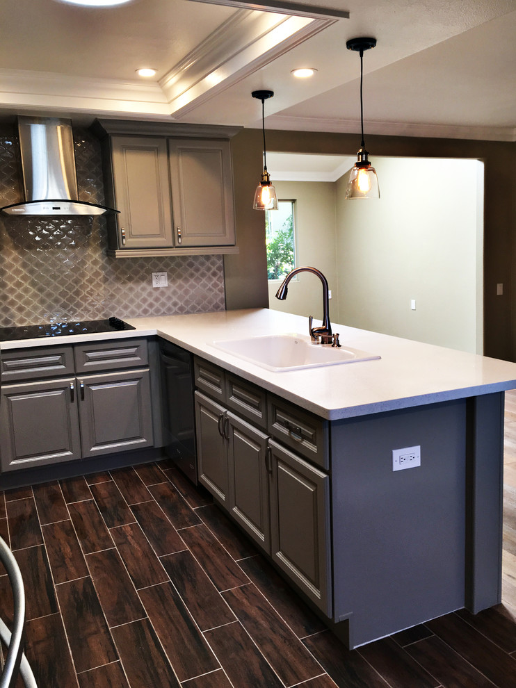 Example of a mid-sized transitional u-shaped dark wood floor eat-in kitchen design in Orange County with raised-panel cabinets, gray cabinets, quartz countertops, a peninsula, a double-bowl sink, brown backsplash, mosaic tile backsplash and stainless steel appliances
