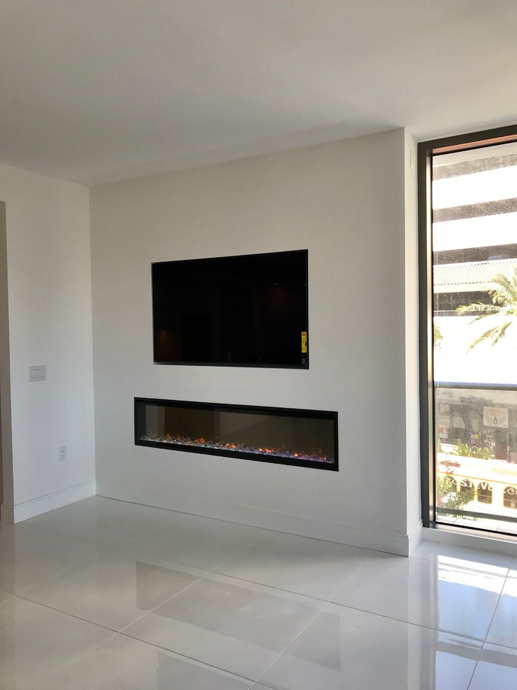 Design ideas for a mid-sized modern living room in Tampa with white walls, porcelain floors, a ribbon fireplace, a plaster fireplace surround, a built-in media wall and white floor.