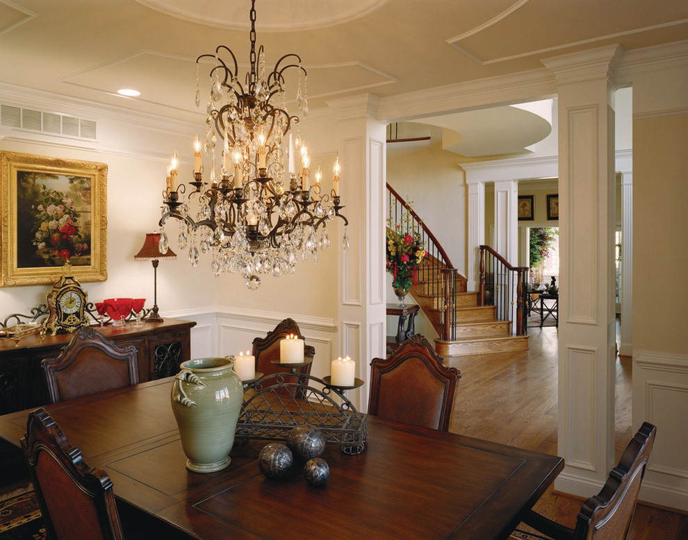 This is an example of a mid-sized traditional separate dining room in Baltimore with beige walls, medium hardwood floors, no fireplace and brown floor.