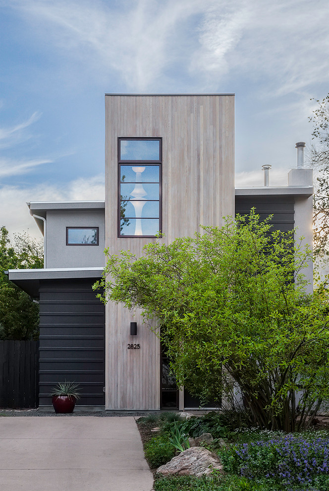 Inspiration for a mid-sized contemporary two-storey grey exterior in Denver with wood siding.