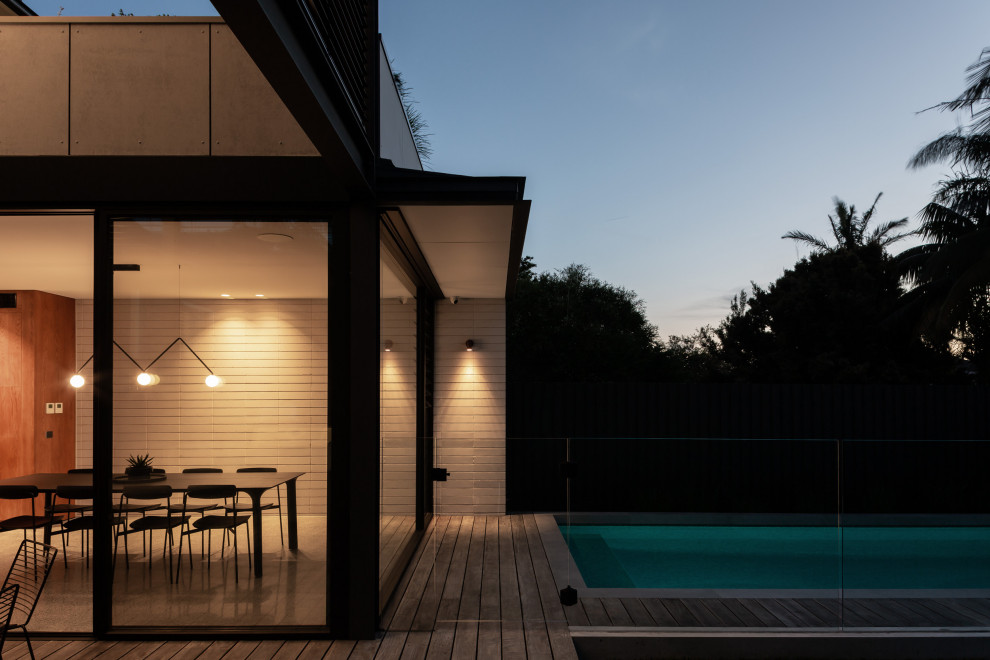 Inspiration for a large contemporary two-storey concrete house exterior in Sydney.