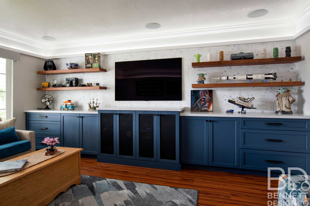 This is an example of a mid-sized eclectic enclosed family room in San Francisco with a game room, white walls, dark hardwood floors, a built-in media wall and recessed.