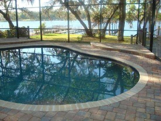 This is an example of a mid-sized indoor round pool in Jacksonville with brick pavers.