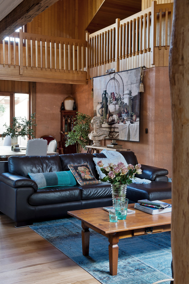 Inspiration for a country open concept living room in Perth with brown walls and light hardwood floors.