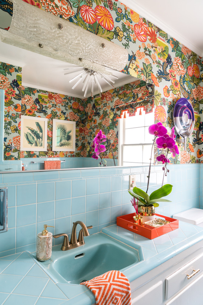 Mid-sized eclectic master bathroom in Los Angeles with flat-panel cabinets, white cabinets, an alcove tub, an alcove shower, a bidet, blue tile, ceramic tile, multi-coloured walls, ceramic floors, an undermount sink, tile benchtops, turquoise floor, a hinged shower door and turquoise benchtops.