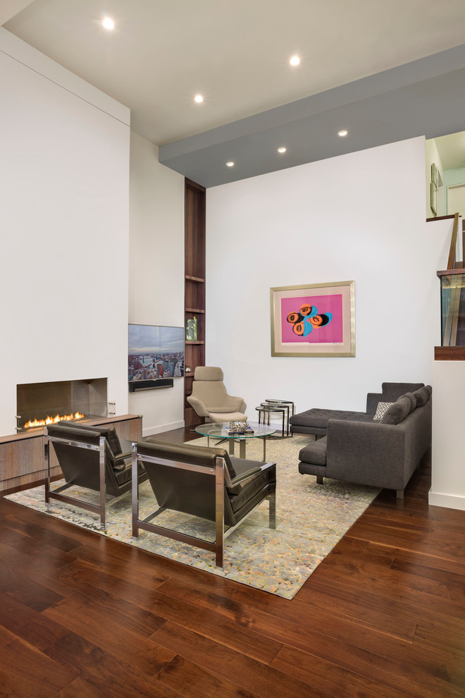 Photo of a large contemporary formal open concept living room in New York with white walls, dark hardwood floors, a ribbon fireplace, a wall-mounted tv, a plaster fireplace surround and brown floor.