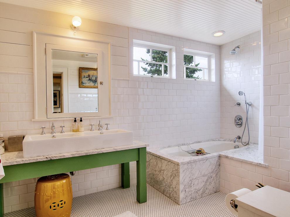 Photo of an eclectic bathroom in Seattle with a trough sink, green cabinets, a shower/bathtub combo, white tile, subway tile and an undermount tub.