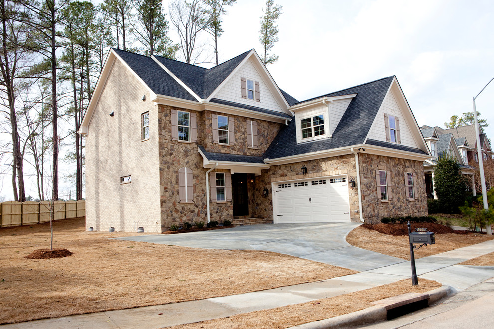 Photo of a mid-sized country two-storey beige exterior in Raleigh with stone veneer.