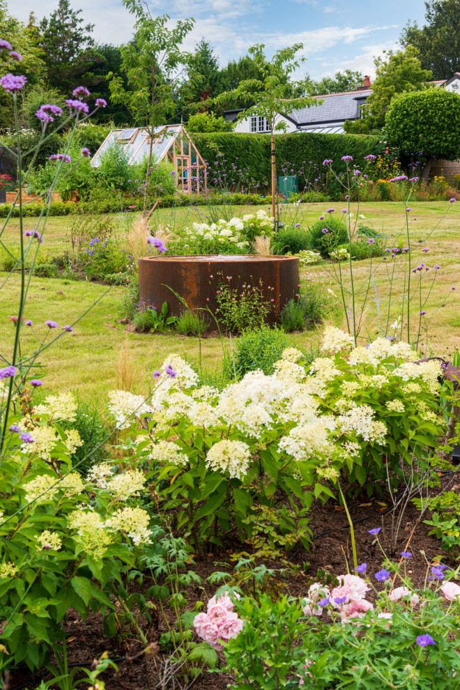 Inspiration for a large country backyard full sun garden in Hampshire with with flowerbed.