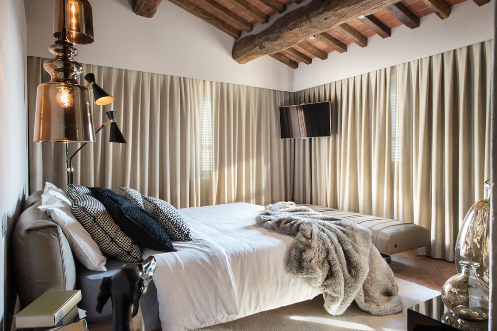 Inspiration for a large contemporary master bedroom in Florence with white walls and brick floors.