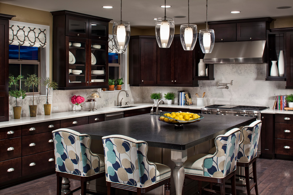 Photo of a contemporary kitchen in Denver with flat-panel cabinets, dark wood cabinets and stainless steel appliances.
