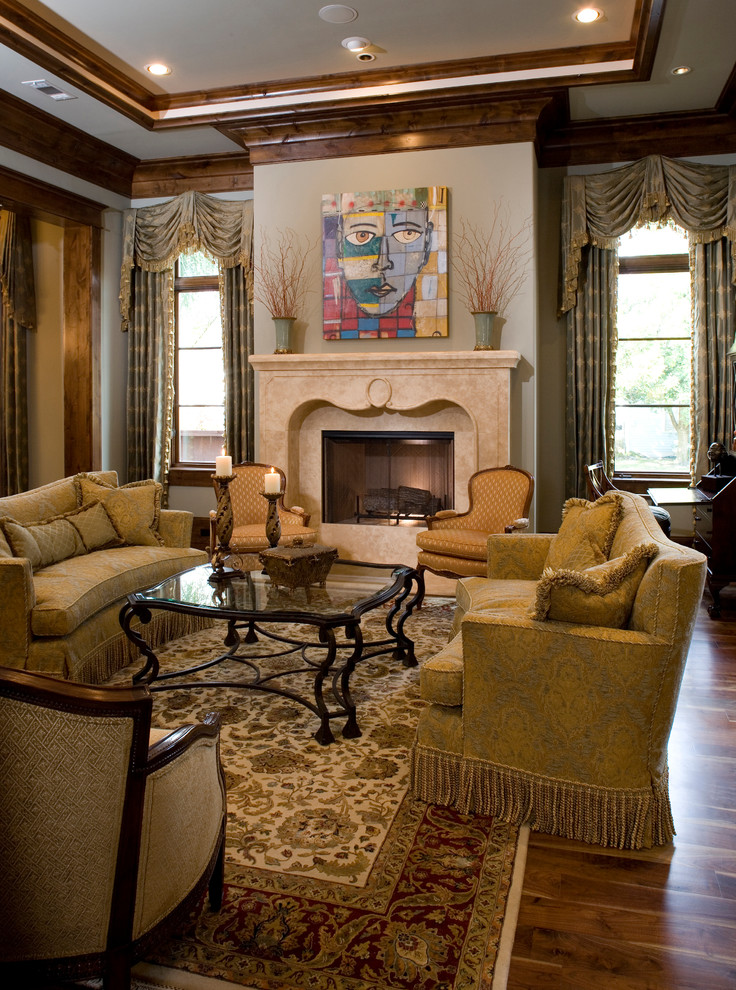 Photo of a traditional family room in Houston with beige walls, a standard fireplace and a stone fireplace surround.