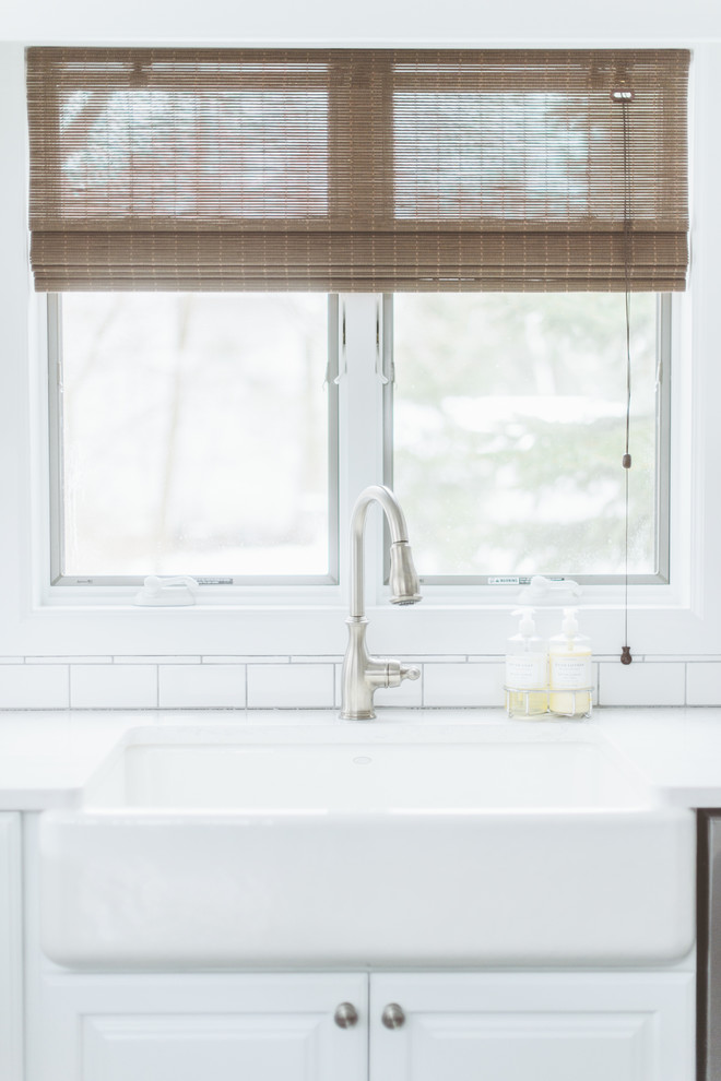 Inspiration for a transitional kitchen remodel with a farmhouse sink, recessed-panel cabinets and white cabinets