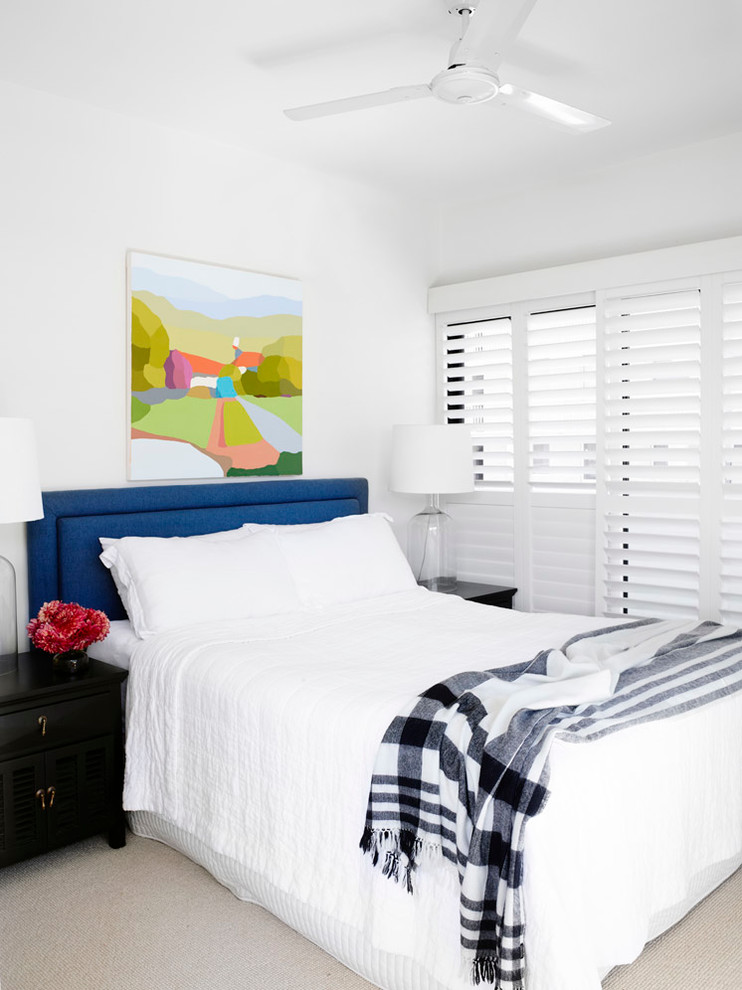 Photo of a transitional bedroom in Brisbane with white walls and carpet.