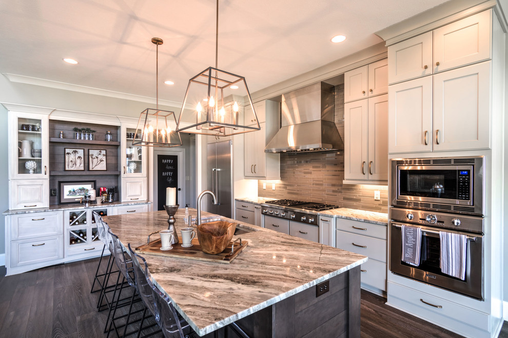 Design ideas for a modern l-shaped kitchen in Indianapolis with shaker cabinets, white cabinets, stainless steel appliances, dark hardwood floors, with island, quartzite benchtops, grey splashback and porcelain splashback.