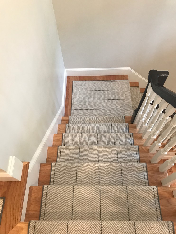 Small traditional wood straight wood railing staircase in Boston with carpeted risers.