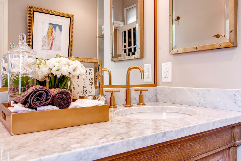 Mid-sized transitional master bathroom in Denver with shaker cabinets, medium wood cabinets, a corner shower, white tile, stone slab, grey walls, ceramic floors, an undermount sink and marble benchtops.