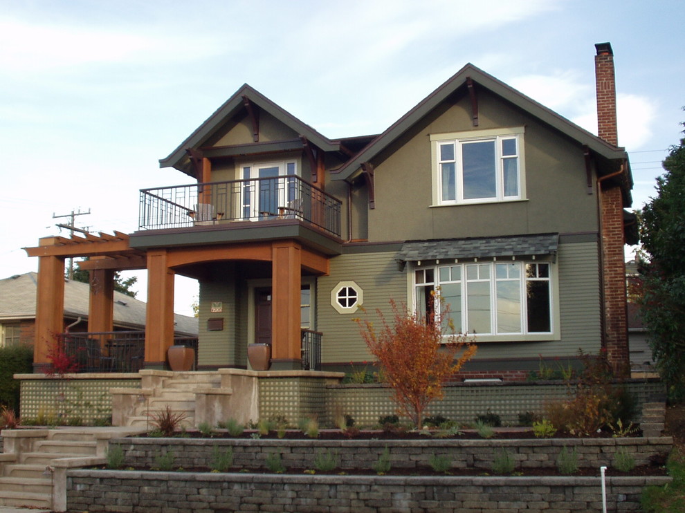Inspiration for a large arts and crafts two-storey green exterior in Seattle with mixed siding.
