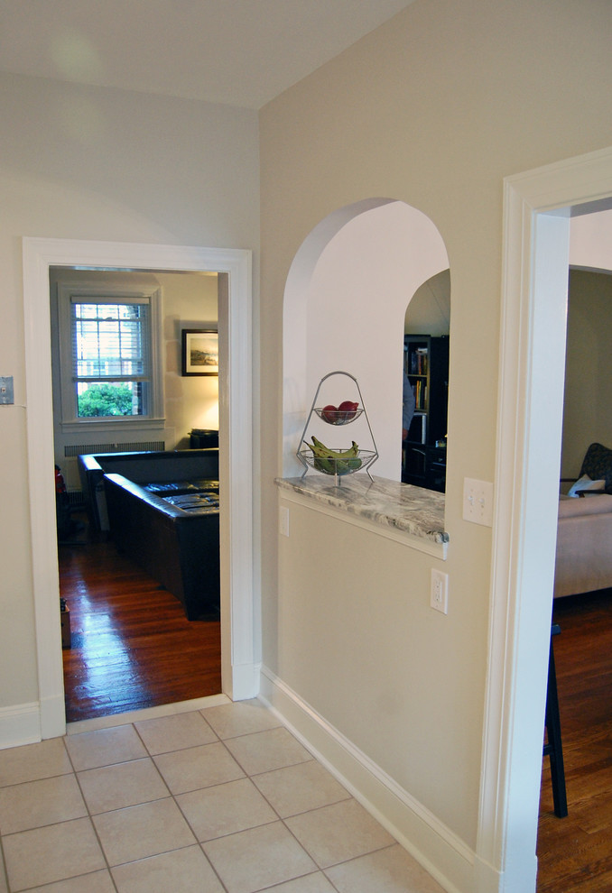 Example of a small transitional kitchen design in Baltimore with a drop-in sink, flat-panel cabinets, white cabinets and an island