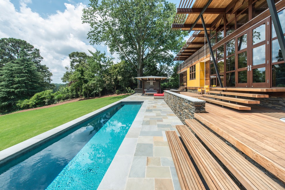 Mid-sized midcentury backyard rectangular lap pool in Atlanta with concrete pavers.