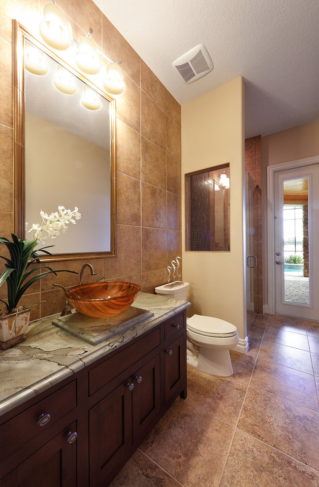 Inspiration for a transitional bathroom in Orlando with raised-panel cabinets, medium wood cabinets, a drop-in tub, a corner shower, beige tile, ceramic tile, beige walls, porcelain floors, a vessel sink, soapstone benchtops, beige floor and an open shower.