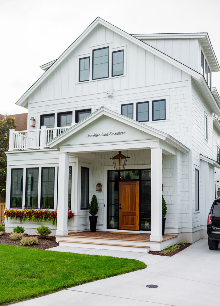 Large cottage white three-story concrete fiberboard house exterior photo