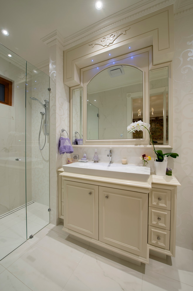 Design ideas for a mid-sized transitional 3/4 bathroom in Perth with a vessel sink, beaded inset cabinets, solid surface benchtops, white tile, ceramic tile, white walls, ceramic floors and an alcove shower.