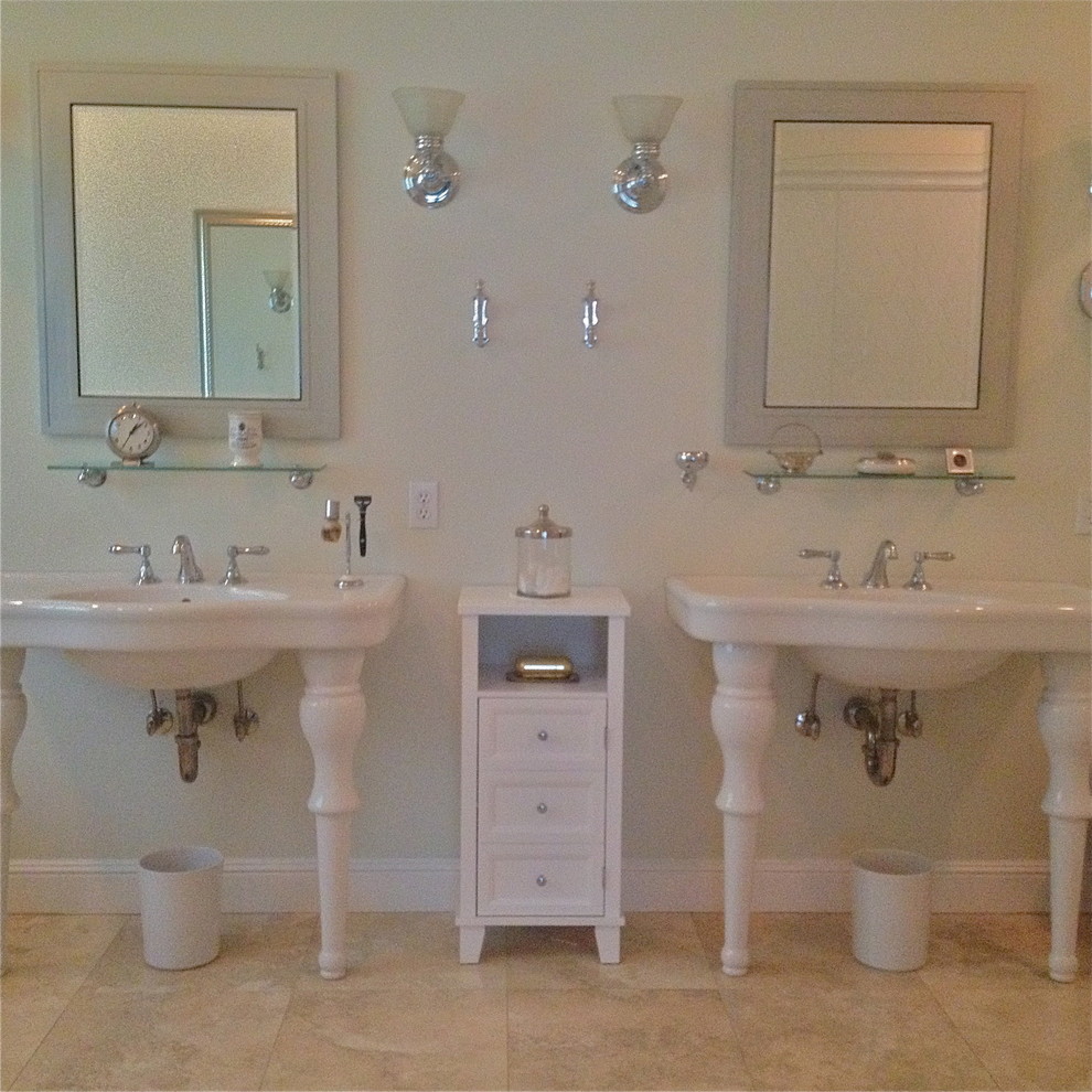 Photo of a mid-sized traditional master bathroom in Portland with white cabinets, a pedestal sink, a drop-in tub, a double shower, a two-piece toilet, stone tile, white walls and travertine floors.