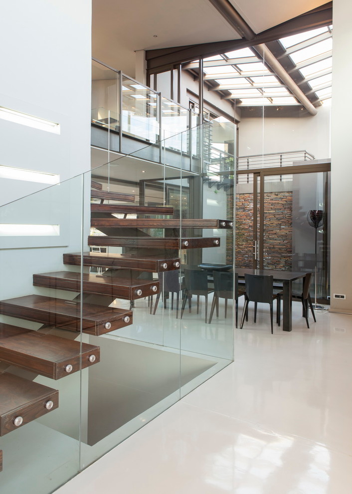 Inspiration for a contemporary wood floating staircase in Other with open risers.