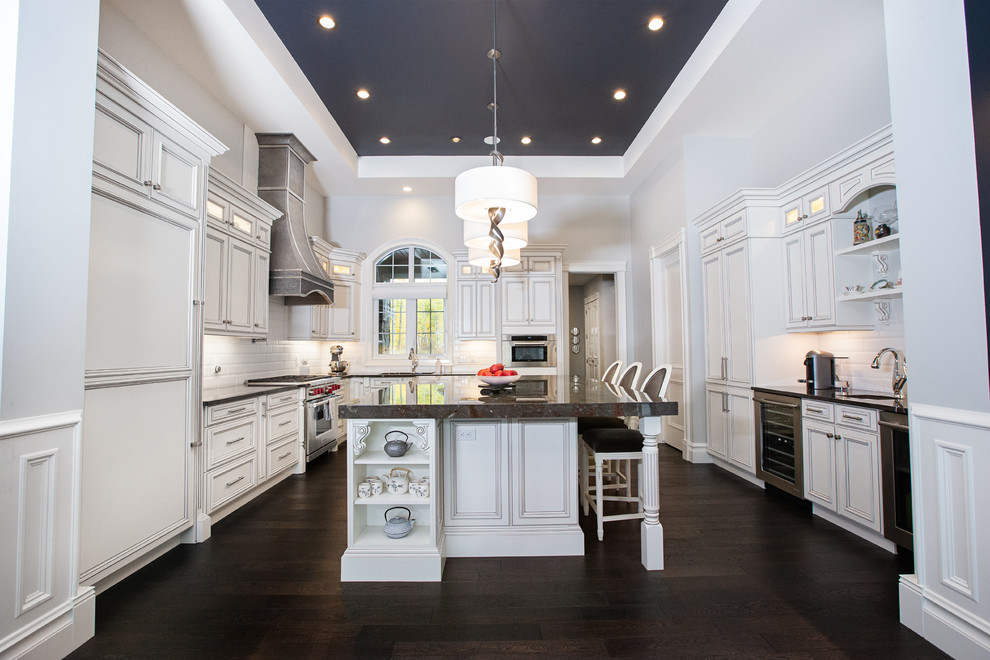Example of a large transitional galley ceramic tile and brown floor eat-in kitchen design in Edmonton with a farmhouse sink, beaded inset cabinets, white cabinets, quartzite countertops, gray backsplash, marble backsplash, stainless steel appliances, an island and gray countertops