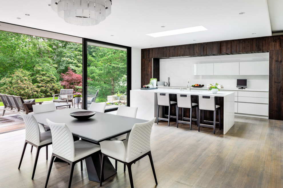 Contemporary eat-in kitchen in Boston with quartz benchtops, white benchtop, white splashback and engineered quartz splashback.