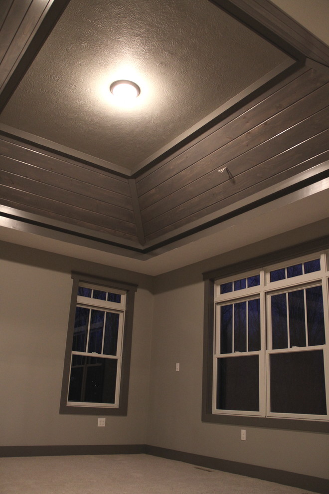 Example of a mid-sized mountain style guest carpeted and brown floor bedroom design with no fireplace and gray walls
