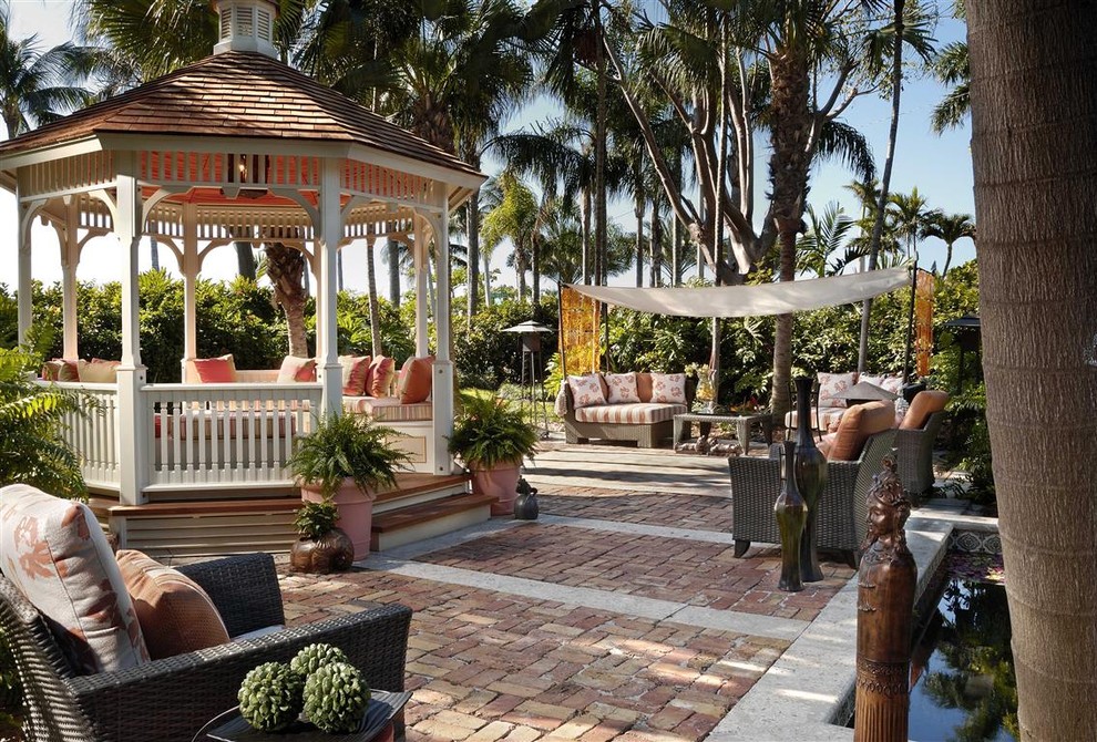 Tropical patio in Miami with a gazebo/cabana.