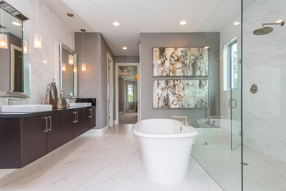 Photo of a transitional master bathroom in Orlando with flat-panel cabinets, dark wood cabinets, a freestanding tub, a curbless shower, grey walls, a wall-mount sink and a hinged shower door.