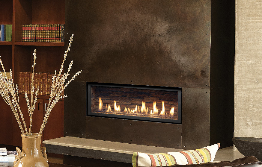 Photo of an industrial living room in Phoenix with grey walls, a ribbon fireplace and a metal fireplace surround.