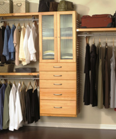 Mid-sized arts and crafts walk-in wardrobe in Jacksonville with light wood cabinets.