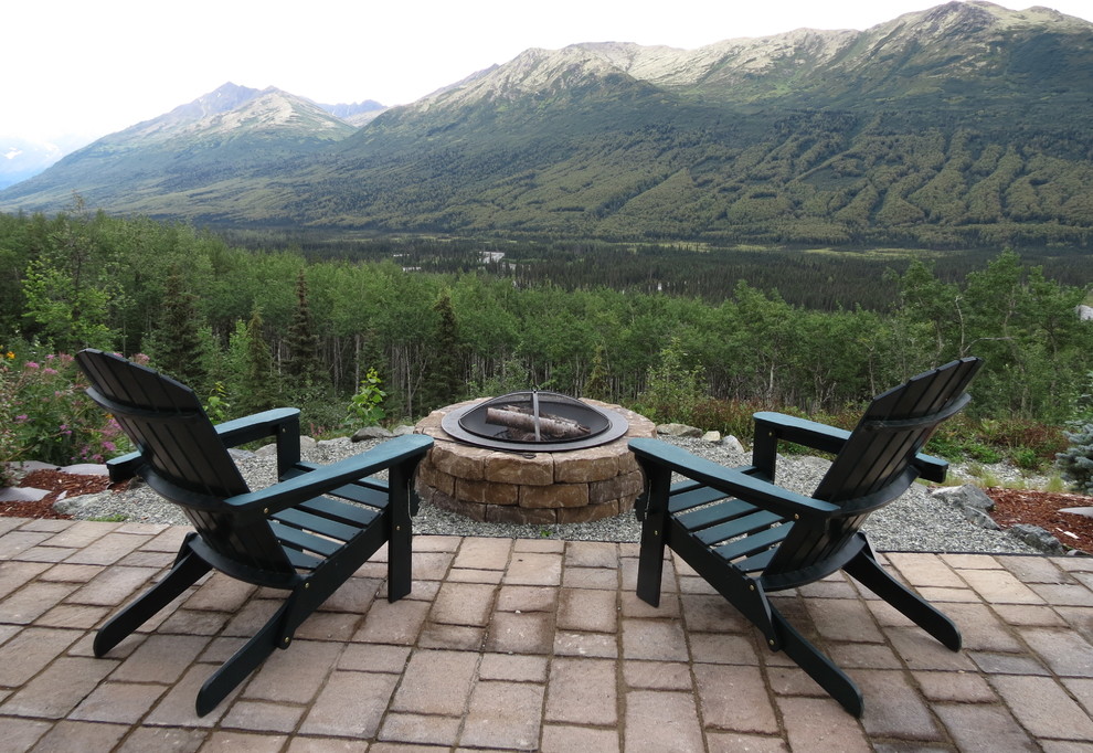 Inspiration for a mid-sized rustic backyard concrete paver full sun patio remodel