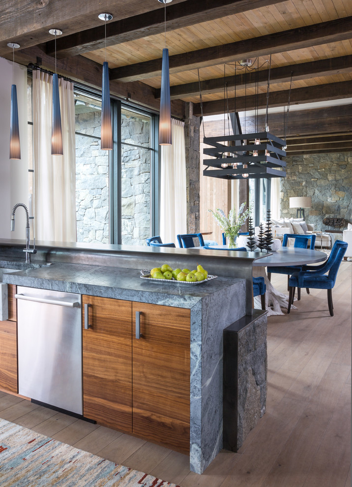 Design ideas for a contemporary eat-in kitchen in Denver with a farmhouse sink, flat-panel cabinets, medium wood cabinets, stainless steel appliances, light hardwood floors, beige floor, grey benchtop, exposed beam and a peninsula.