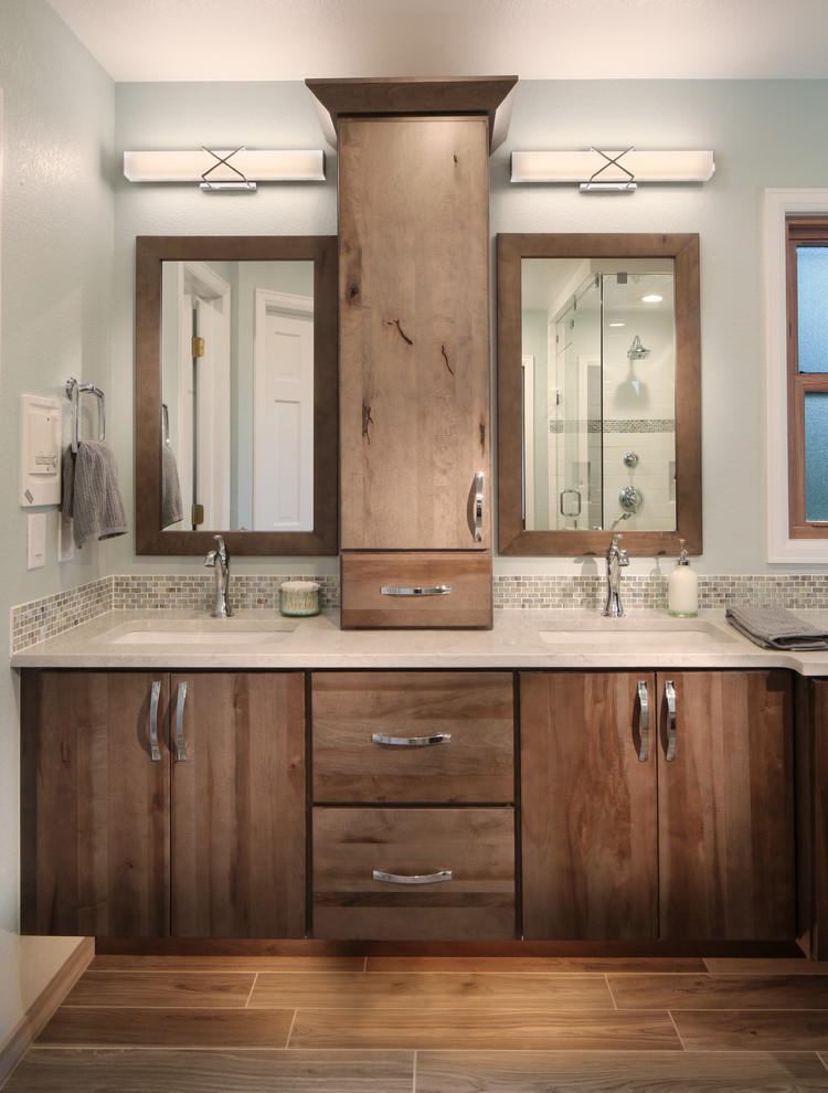 Inspiration for a transitional master multicolored tile and mosaic tile porcelain tile bathroom remodel in Denver with flat-panel cabinets, medium tone wood cabinets, an undermount sink and quartz countertops