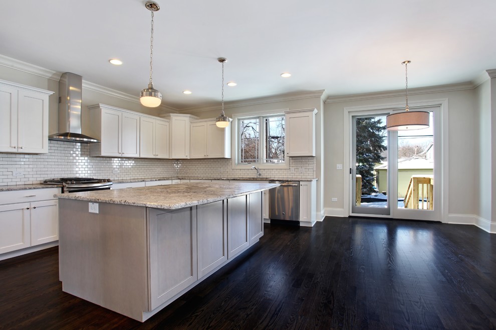 Inspiration for a large transitional u-shaped dark wood floor open concept kitchen remodel in Chicago with an undermount sink, recessed-panel cabinets, gray cabinets, granite countertops, white backsplash, ceramic backsplash, stainless steel appliances and an island