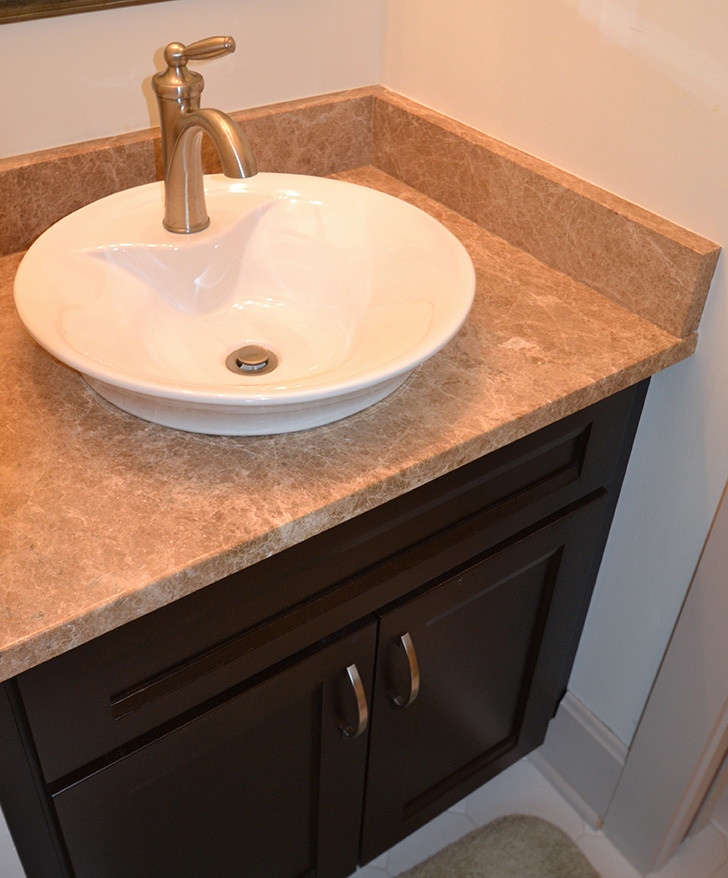 Small transitional home design photo in Columbus with a vessel sink, recessed-panel cabinets, dark wood cabinets and beige walls