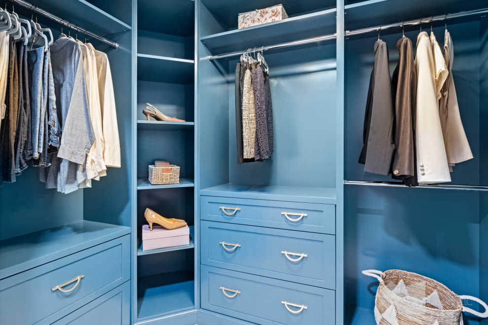 Mid-sized traditional gender-neutral dressing room in Other with shaker cabinets, blue cabinets, marble floors, multi-coloured floor and wood.