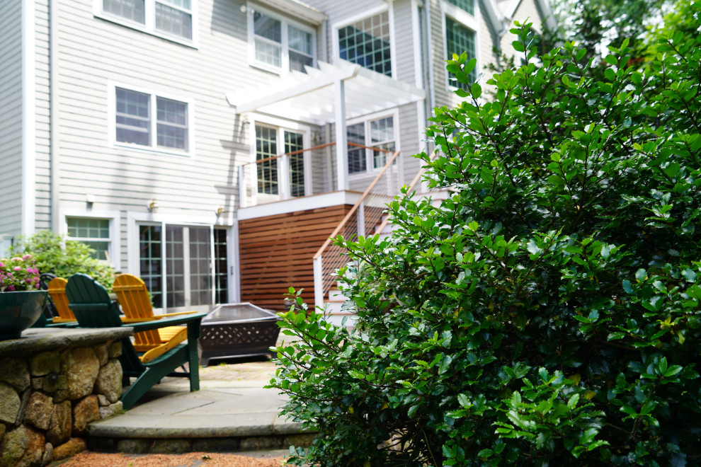 Photo of a medium sized contemporary side ground level wire cable railing terrace in Boston with an outdoor kitchen and a pergola.