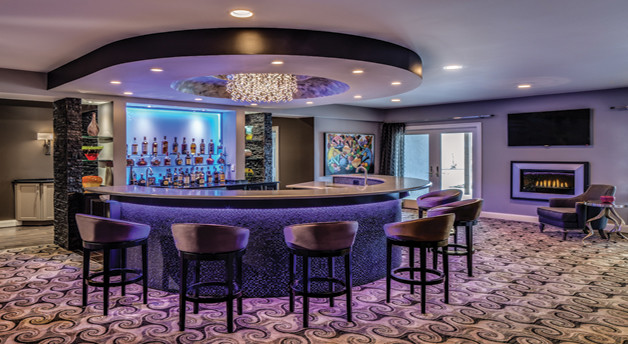 This is an example of a large eclectic u-shaped seated home bar in DC Metro with an undermount sink, open cabinets, quartz benchtops, carpet and multi-coloured floor.