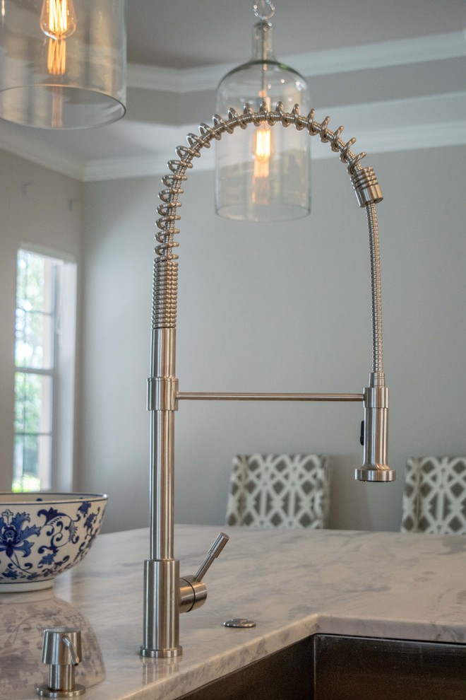 Example of a mid-sized transitional single-wall light wood floor and beige floor open concept kitchen design in Miami with shaker cabinets, an island, an undermount sink, white cabinets, marble countertops, white backsplash, subway tile backsplash and stainless steel appliances