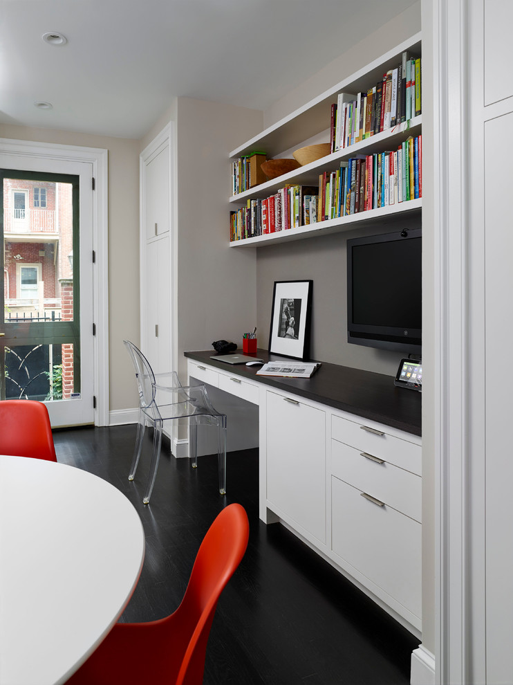 Transitional study room in Philadelphia with a built-in desk, grey walls and black floor.