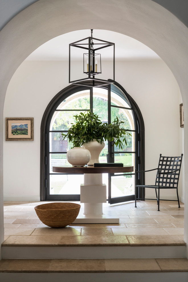 Inspiration for a large transitional foyer in Austin with white walls, ceramic floors, a double front door, a black front door and beige floor.