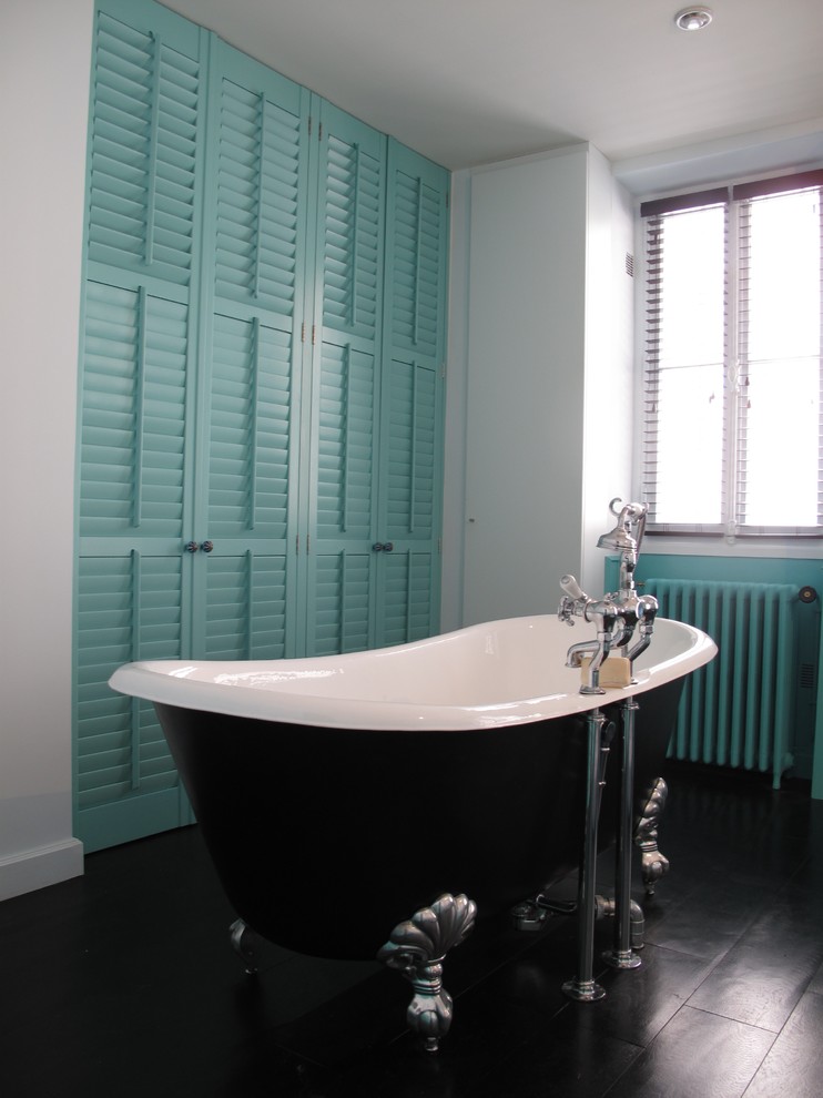Inspiration for a transitional bathroom in Paris with green cabinets and a claw-foot tub.