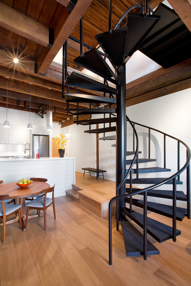 This is an example of a mid-sized industrial metal spiral staircase in Vancouver with open risers.