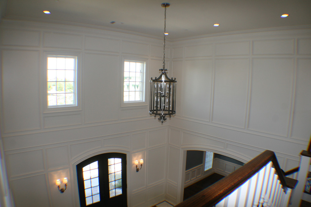 This is an example of an expansive arts and crafts foyer in Dallas with white walls, dark hardwood floors, a double front door and a dark wood front door.
